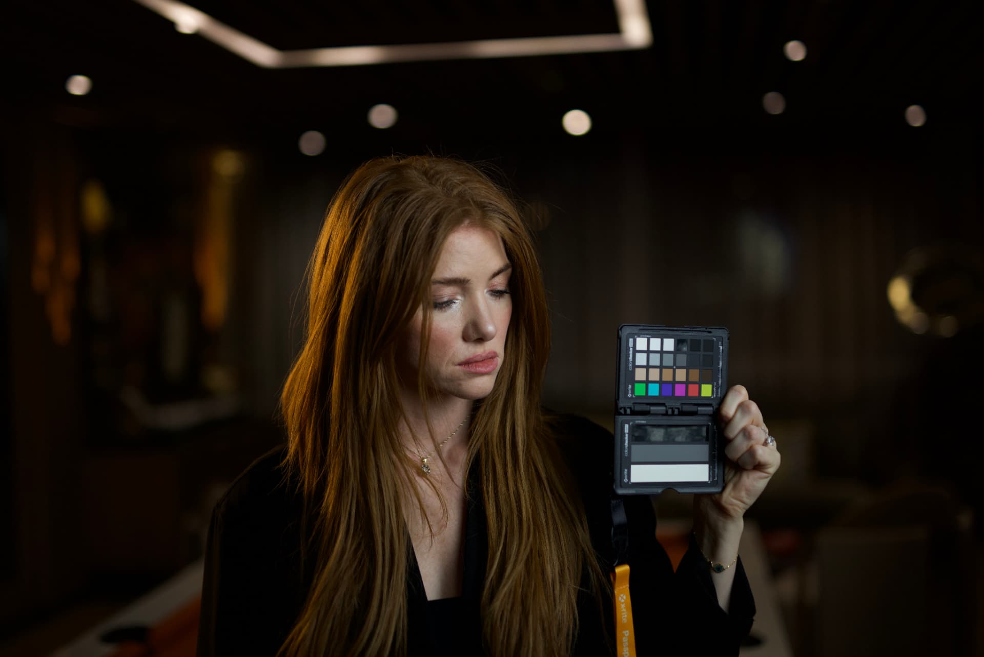 Kristen reviewing a colour chart on set