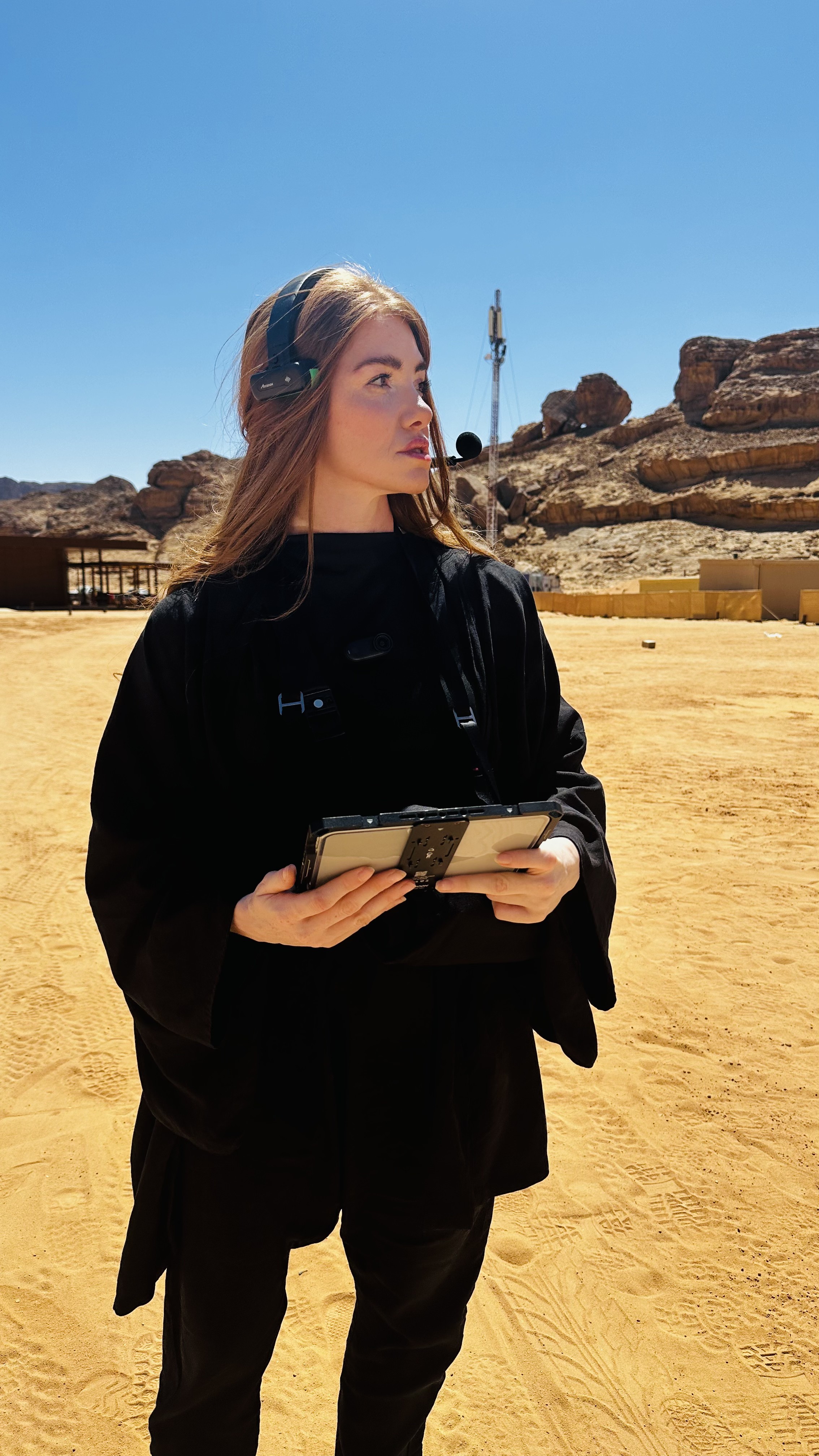 Kristen on comms with a tablet, on location in AlUla, Saudi Arabia