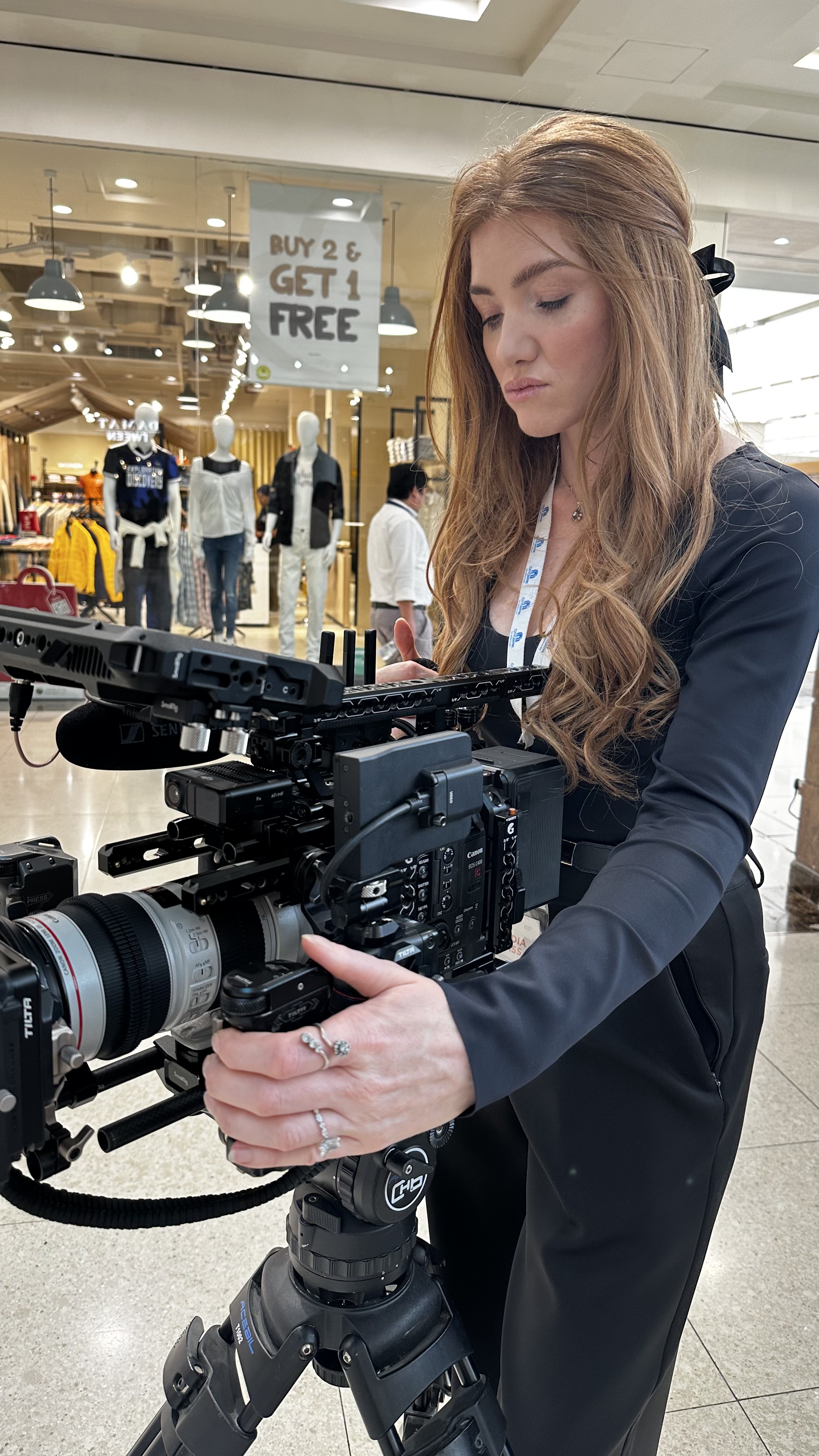 Kristen operating the cinema camera on a mall location shoot
