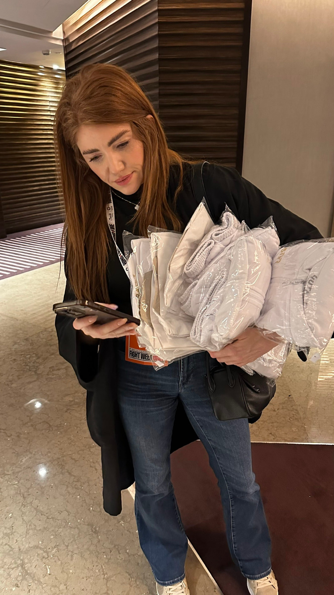 Kristen hauling kit in a hotel lobby during Riyadh Season fight week