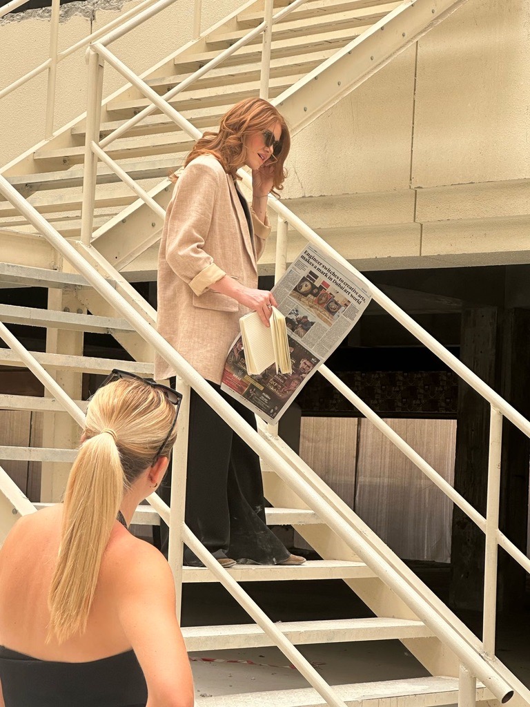 Kristen directing on location from the staircase